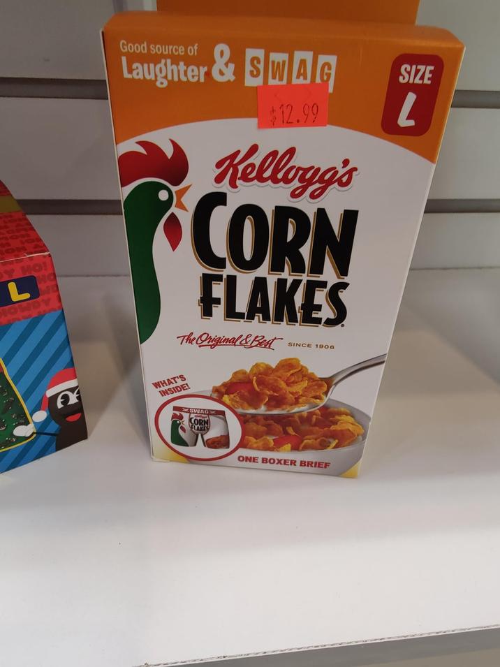 ค Good source of Laughter & SWAG $12.99 Kellogg's CORN FLAKES The Original & Best WHAT'S INSIDE! SWAG CORN FLAKES SINCE 1906 SIZE L DY HO! L HOWD HO ONE BOXER BRIEF