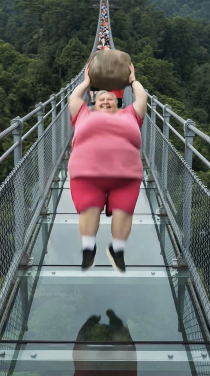 AI Lady jumping backward with rock on glass bridge (reaction image) A "reaction image":https://knowyourmeme.com/memes/reaction-images of a woman in a pink shirt jumping backward with a big rock on a glass bridge to break the bridge from a viral "AI Video":https://knowyourmeme.com/memes/cultures/ai-video.