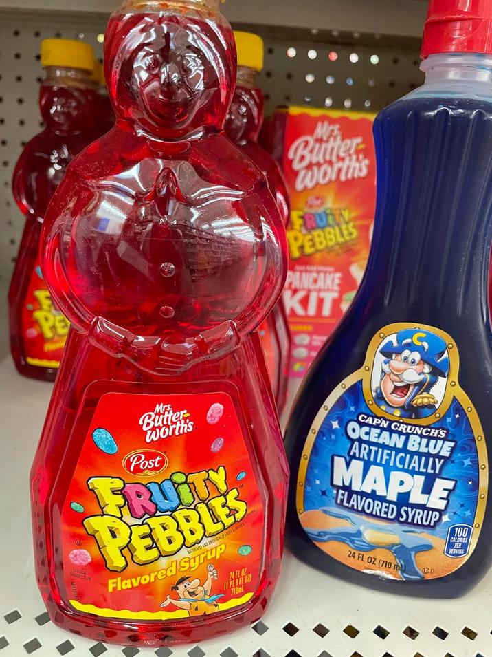 PE Mrs Butter Worth's FRUITY PEBBLES PANCAKE KIT Mrs. Butter worth's Post FRUITY PEBBLES NATURALLY AND ARTIFICIALLY FRUIT FLAVORED Flavored Syrup 24 FL OZ (1 PT 8 FL OZ) 710ml SUGGESTION O CAPN CRUNCH'S OCEAN BLUE ARTIFICIALLY MAPLE FLAVORED SYRUP 100 CALORIES PER SERVING 24 FL OZ (710 m) D