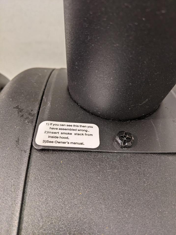 1) If you can see this then you have assembled wrong. 2) Insert smoke stack from inside hood. 3)See Owner's manual.