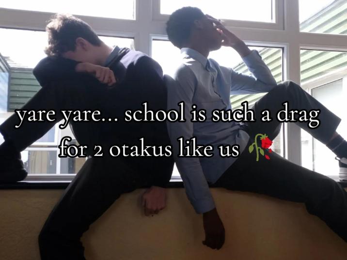 A photo of two boys posing back-to-back in a window. The meme is captioned, "yare yare... school is such a drag for two otakus like us."