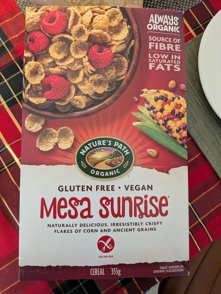 NATURE'S PATH ALWAYS ORGANIC SOURCE OF FIBRE LOW IN SATURATED FATS ORGANIC GLUTEN FREE VEGAN Mesa sunrise NATURALLY DELICIOUS, IRRESISTIBLY CRISPY FLAKES OF CORN AND ANCIENT GRAINS GB-169-005 CEREAL 355g FRUIT SHOWN AS SERVING SUGGESTION