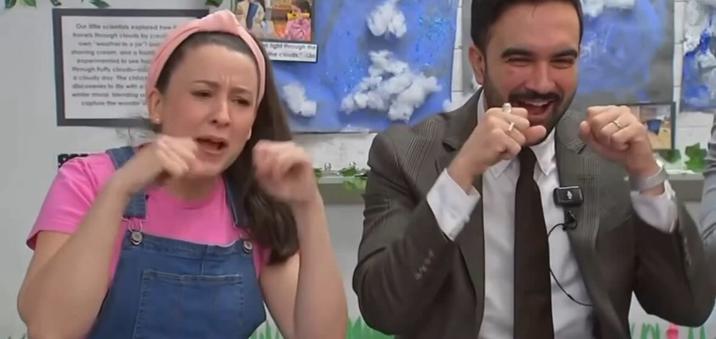 A reaction image. The image shows Zohran Mamdani and Ms. Rachel pretending to cry while singing "Wheels on the Bus."