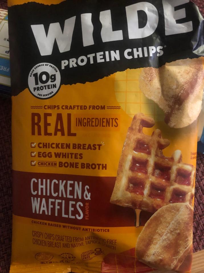 A WILDE GOOD SOURCE OF PROTEIN 109 PROTEIN SERVING PER PROTEIN CHIPS www.CHIPS CRAFTED FROM REAL INGREDIENTS CHICKEN BREAST EGG WHITES ING CHICKEN BONE BROTH CHICKEN & WAFFLES! CHICKEN RAISED WITHOUT ANTIBIOTICS CRISPY CHIPS CRAFTED FROM APIOCA STAR CHICKEN BREAST AND NATIVE T ALEO BET250 TEARY CERTIFIED GLUTEN FREE Enlarge