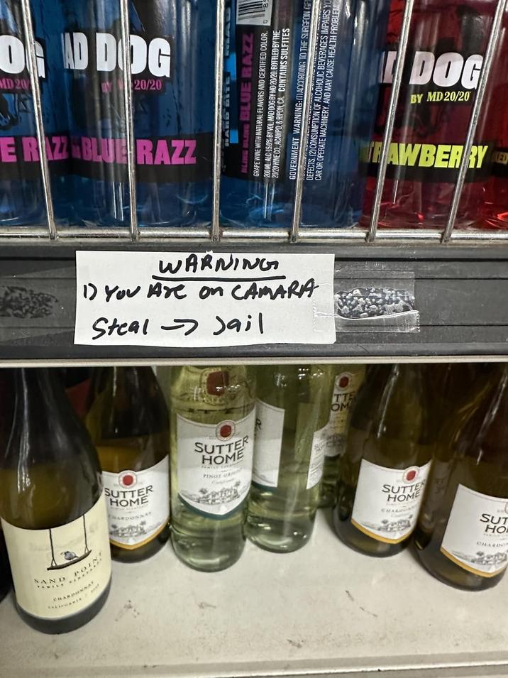 DEAD DOG MD 20 20/20 ERAZZ BLUE RAZZ SAND BLING BLING BLUE RAZZ GRAPE WINE WITH NATURAL FLAVORS AND CERTIFIED COLOR. 200 ML. ALC 15.0% BY VOL MAD DOG BY MD 20/20. BOTTLED BY THE 20/20 WINE CO., ACAMPO, & RIPON, CA. CONTAINS SULFITES GOVERNMENT WARNING:(DACCORDING TO THE SURGEON GET DEFECTS. (2) CONSUMPTION OF AL OF ALCOHOLIC BEVERAGES IMPAIRS YO CAR OR OPERATE MACHINERY. AND MAY CAUSE HEALTH PROBLEM 1) You Are on CAMARA WARNING Steal Jail HOME SUTTER SUTTER HOME TT OM BY MD 20/20 DOG TRAWBERRY ED SUTTE HOME HO SUT CHAER