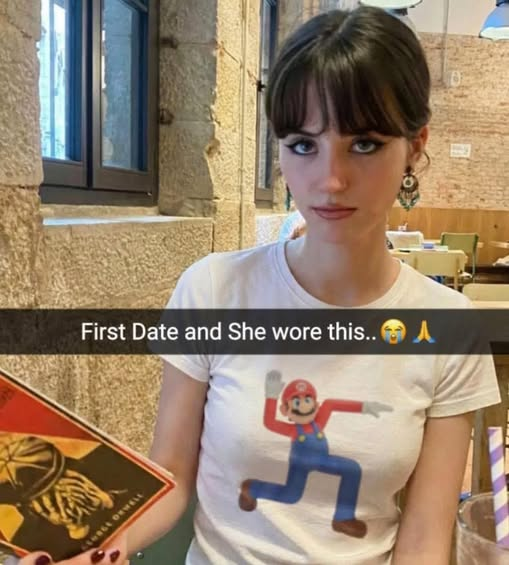A tweet reading, "First date and she shows up wearing this. What do you do? 👀" The photo shows a woman with a Mario shirt.