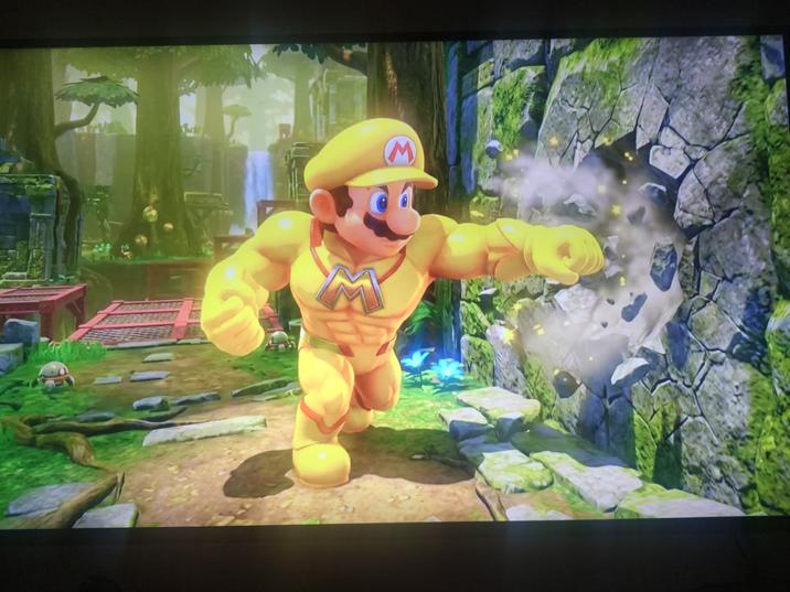 An alleged leaked screenshot from the alleged game Super Mario Titans. It shows Mario punching a wall. 