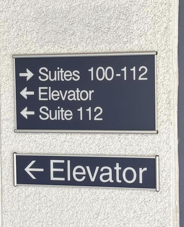 → Suites 100-112 - Elevator <--Suite 112 ← Elevator