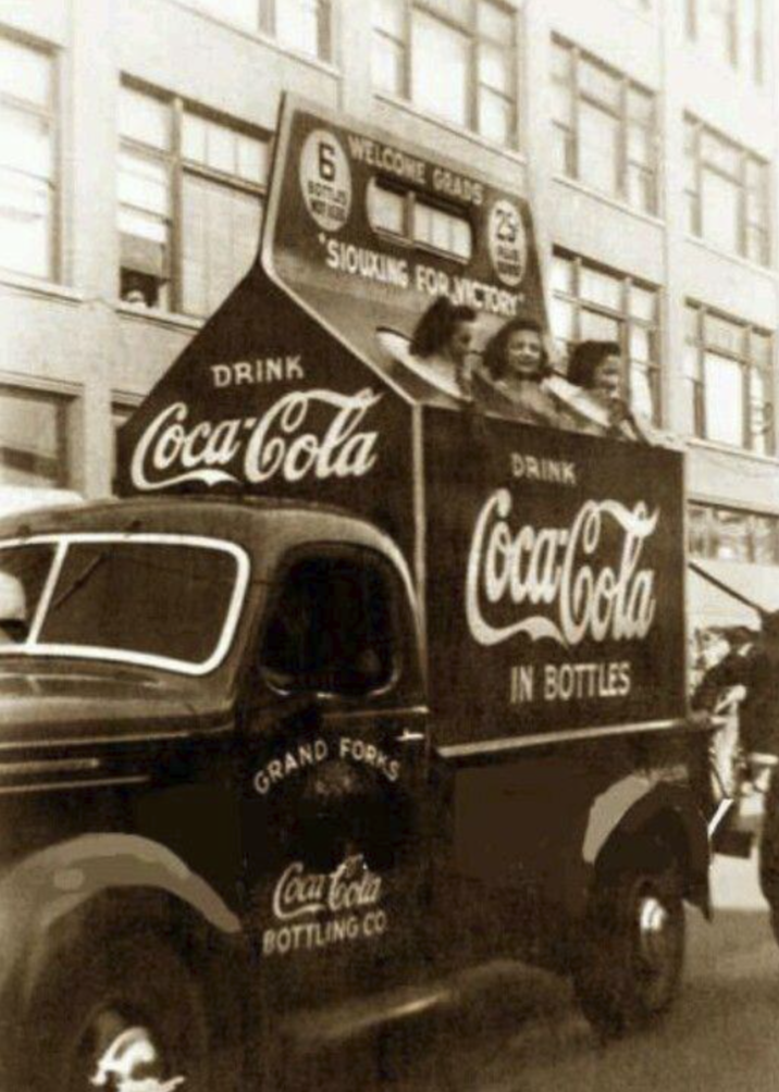 DRINK 6 WELCOME GRADS 3313 SIOUXING FOR VICTORY Coca-Cola GRAND FORKS Coca-Cola BOTTLING CO DRINK Coca-Cola IN BOTTLES
