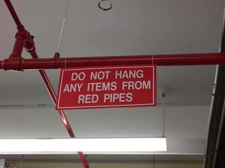 DO NOT HANG ANY ITEMS FROM RED PIPES
