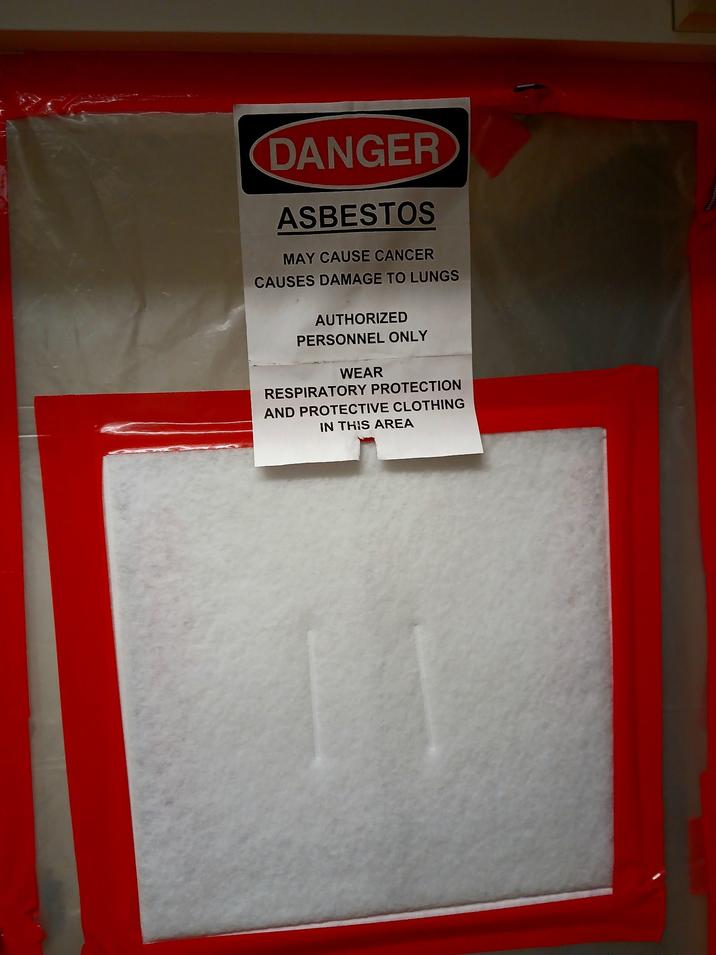 DANGER ASBESTOS MAY CAUSE CANCER CAUSES DAMAGE TO LUNGS AUTHORIZED PERSONNEL ONLY WEAR RESPIRATORY PROTECTION AND PROTECTIVE CLOTHING IN THIS AREA