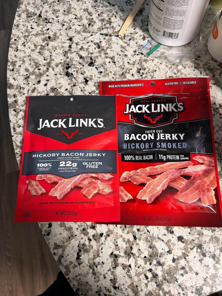 MADE WITH PREMIUM INGREDIENTS GLUTEN FREE 120 CALORIES Pruuldock. BACON JERKY JACK LINK'S HICKORY BACON JERKY 100% THICK CUT BACON SMOKE FLAVOR ADDED 22g PROTEIN PER PACKAGE GLUTEN FREE MEAT SNACKS JACK LINK'S THICK CUT BACON JERKY HICKORY SMOKED SMOKE FLAVOR ADDED 100% REAL BACON 11g PROTEIN PERV SERVING MADE WITH PREMIUM INGREDIENTS NET WT. 2 OZ (56g) NET WT 2.850Z (81g)