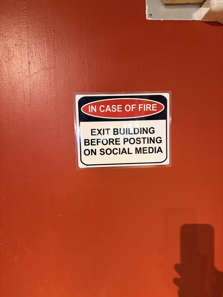 IN CASE OF FIRE EXIT BUILDING BEFORE POSTING ON SOCIAL MEDIA