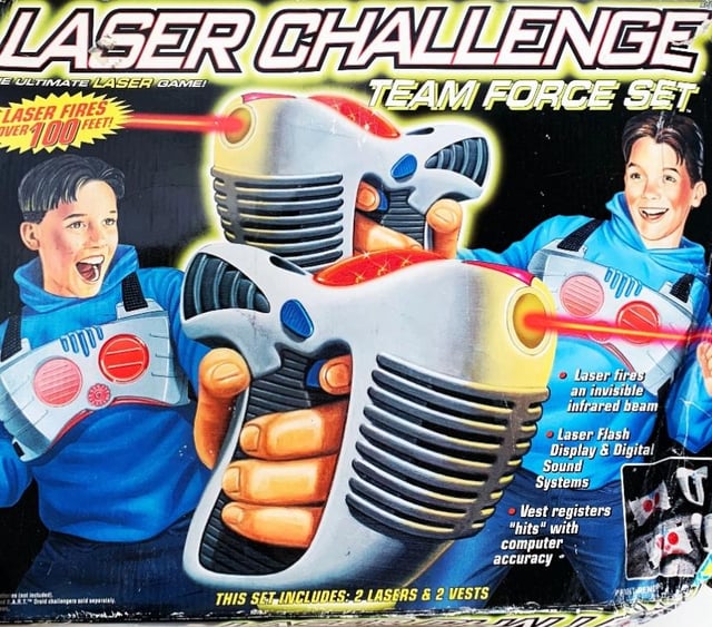 LASER CHALLENGE E ULTIMATE LASER GAME! LASER FIRES VER 100 FEET! TEAM FORCE SET וווו THIS SET INCLUDES: 2 LASERS & 2 VESTS Laser fires an invisible infrared beam Laser Flash Display & Digital Sound Systems ⚫Vest registers "hits" with computer accuracy d