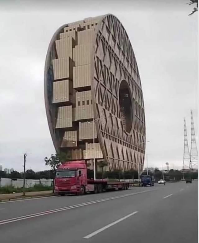 A truck hauling a building