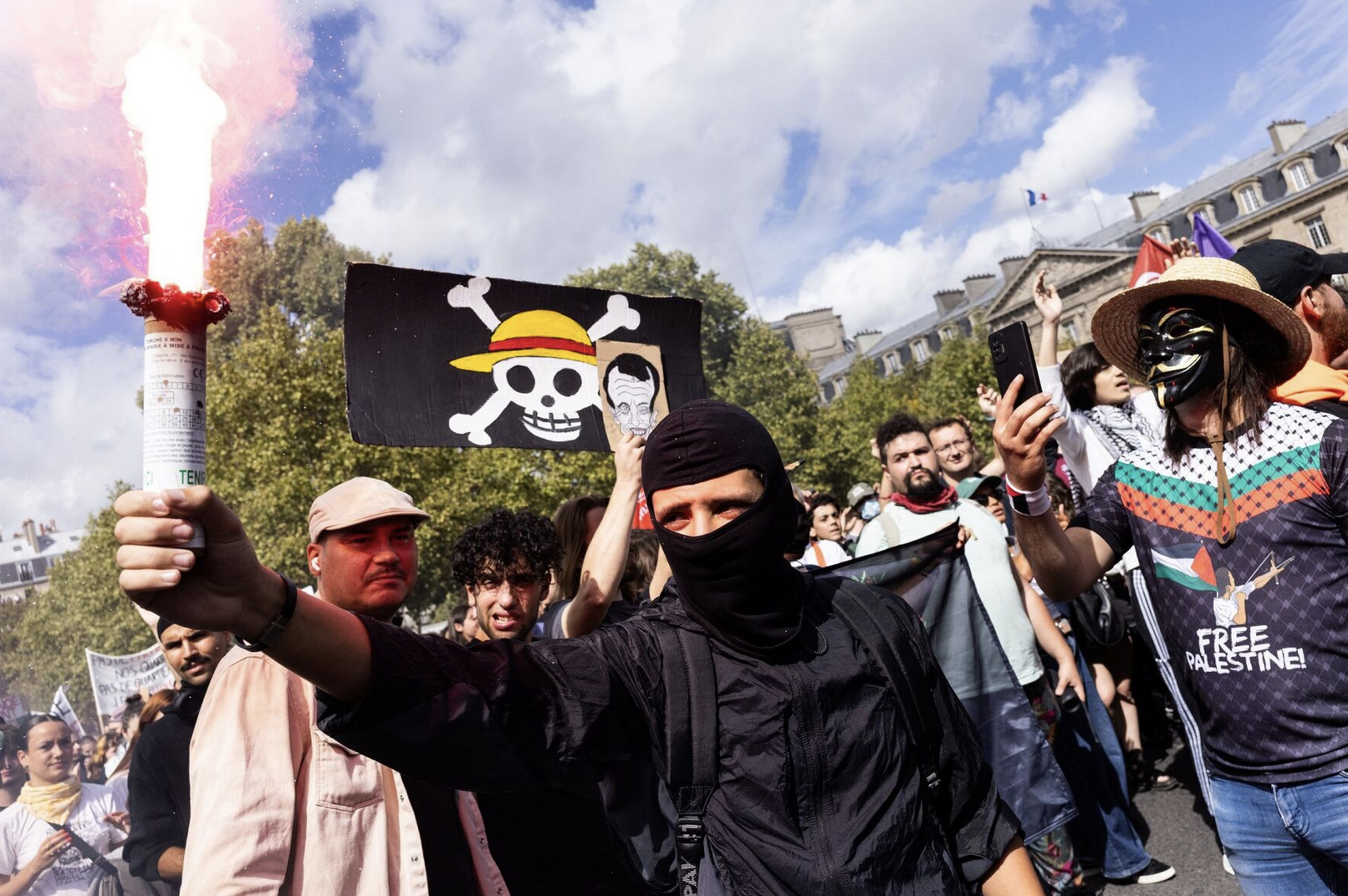 Protesters hold torches during the "Block Everything" protest movement that called for a shutdown of France on September 10 at Republique Square in Paris, France, photographed by Ibrahim Ezzat.