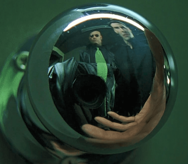 In The Matrix (1999), a camera and crew are reflected in this door ...