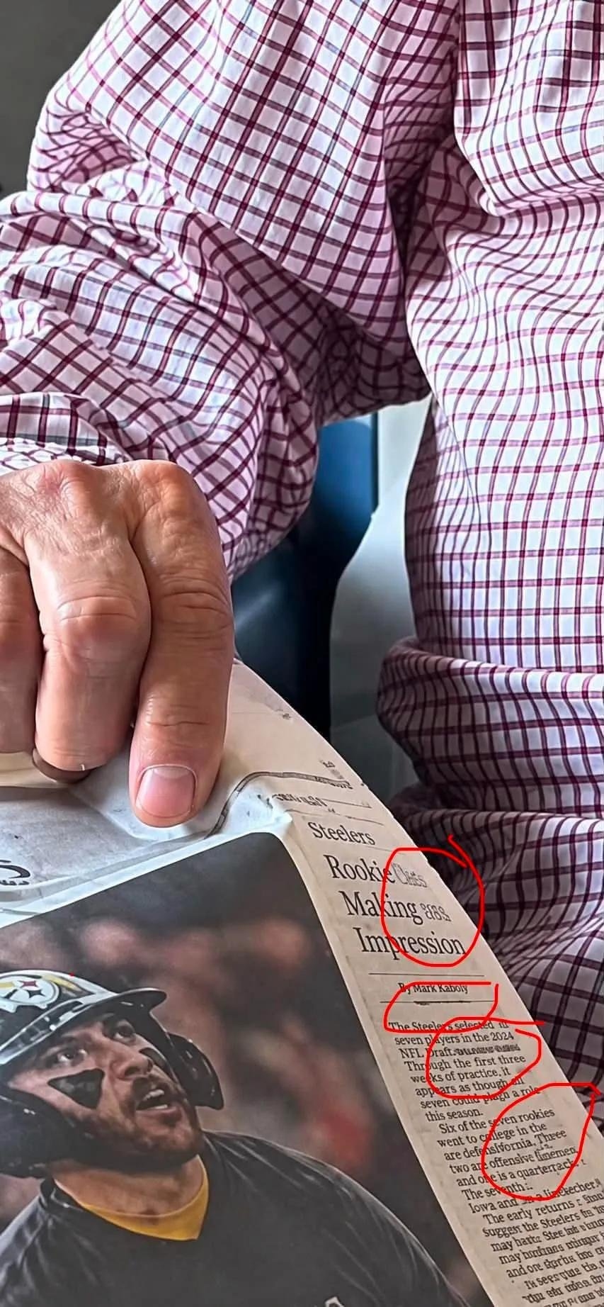 He also looks like he's pushing buttons on a tiny computer mouse embedded in the paper.