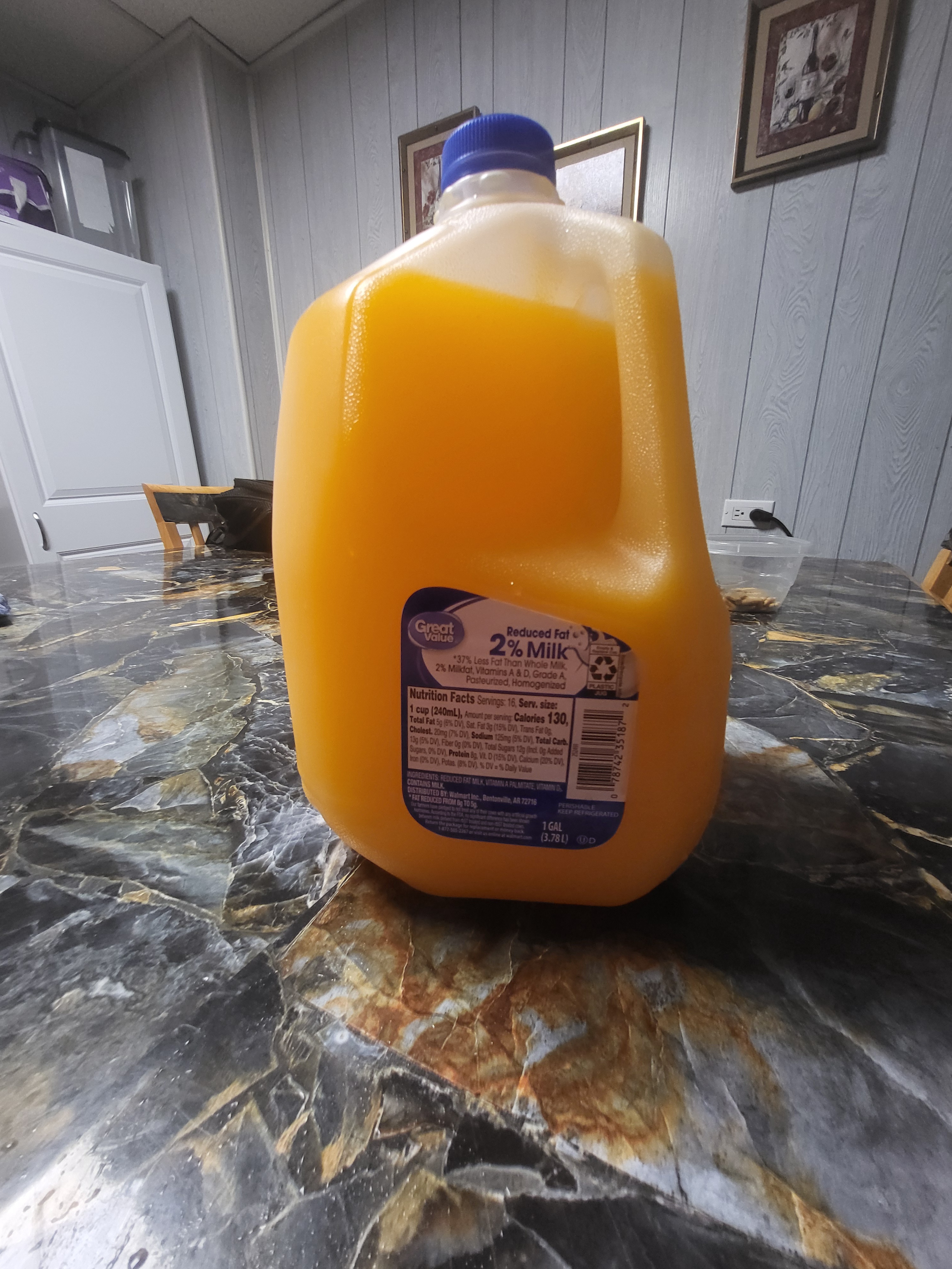 Great Value Reduced Fat 2% Milk *37% Less Fat Than Whole Milk, 2% Milkfat, Vitamins A & D, Grade A Pasteurized, Homogenized Nutrition Facts Servings: 16, Serv. size: 1 cup (240mL), Amount per serving Calories 130, Total Fat 5g (6% DV), Sat. Fat 3g (15% DV), Trans Fat 0g Cholest. 20mg (7% DV), Sodium 125mg (5% DV), Total Carb 13g (5% DV), Fiber 0g (0% DV), Total Sugars 12g (Incl. Og Added Sugars, 0% DV), Protein 8g, Vit. D (15% DV), Calcium (20% DV) fron (0% DV), Potas (8% DV) % DV = % Daily Value INGREDIENTS: REDUCED FAT MILK, VITAMIN A PALMITATE, VITAMIN D CONTAINS MILK DISTRIBUTED BY: Walmart Inc., Bentonville, AR 72716 FAT REDUCED FROM Bg TO 5g Our men have pred to not According to between milk dened Return the package for 1-877-505-2267 an ence has been shown PLASTIC JUG PERISHABLE 2 78742 351 KEEP REFRIGERATED CONG 1 GAL tor money back atmart.com (3.78L) D
